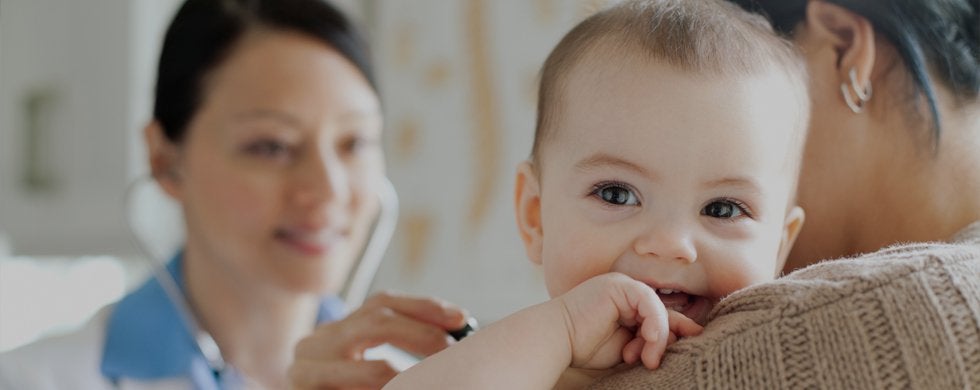 happy-and-smiling-baby-being-examined-by-a-doctor