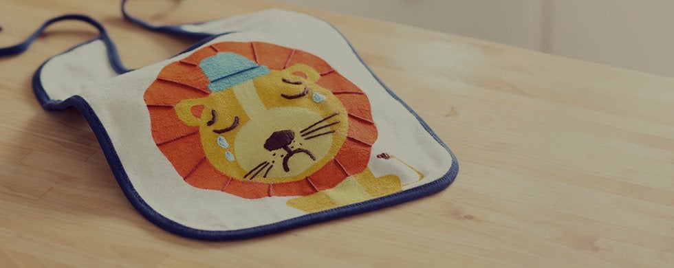 sad-lion-bib-on-a-table