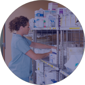 nurse looking at supplies in cupboard